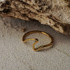 Gold ring on a textured stone surface