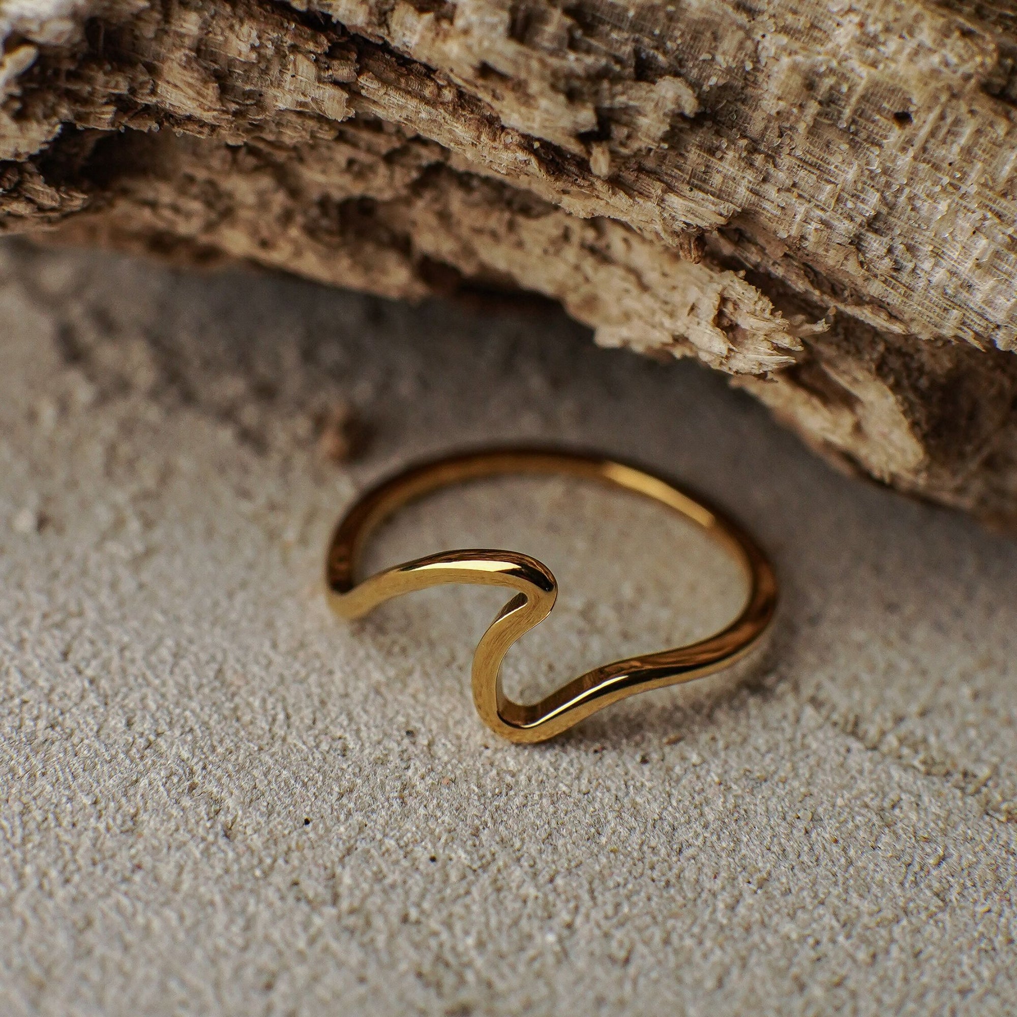Gold ring on a textured stone surface