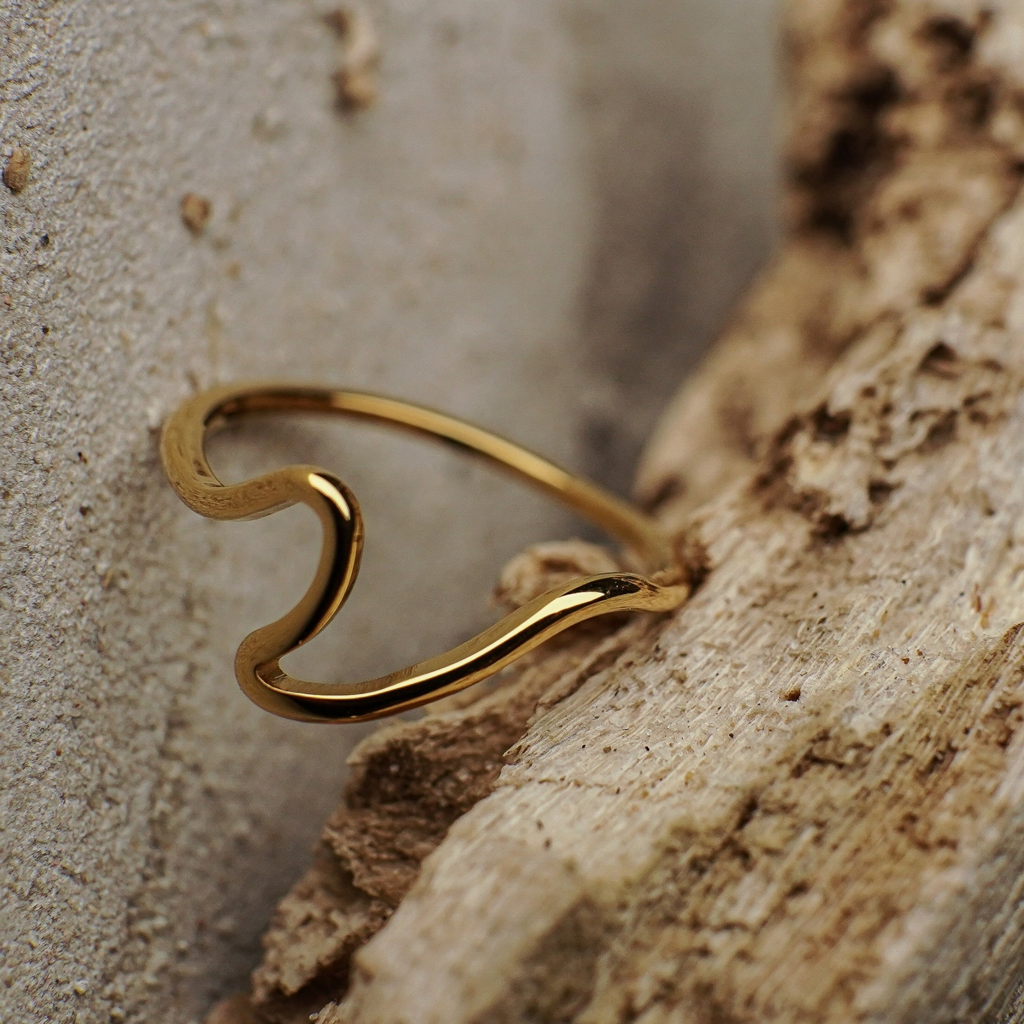 Gold ring on a textured stone surface