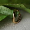 Gold ring on a green leaf with a textured surface