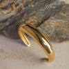 Gold ring on a textured stone surface