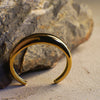 Gold bracelet on a textured stone surface