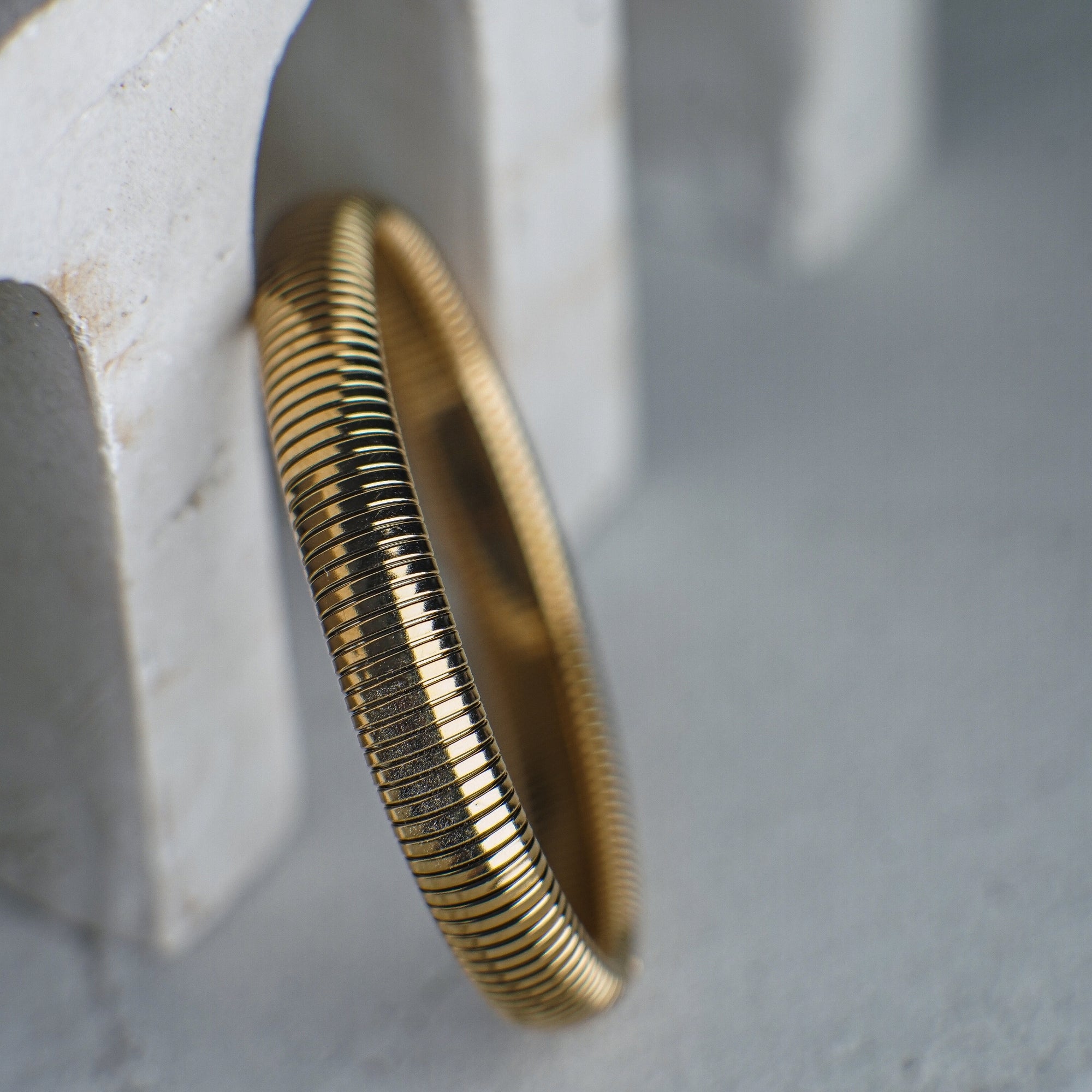 Gold bracelet on a textured surface