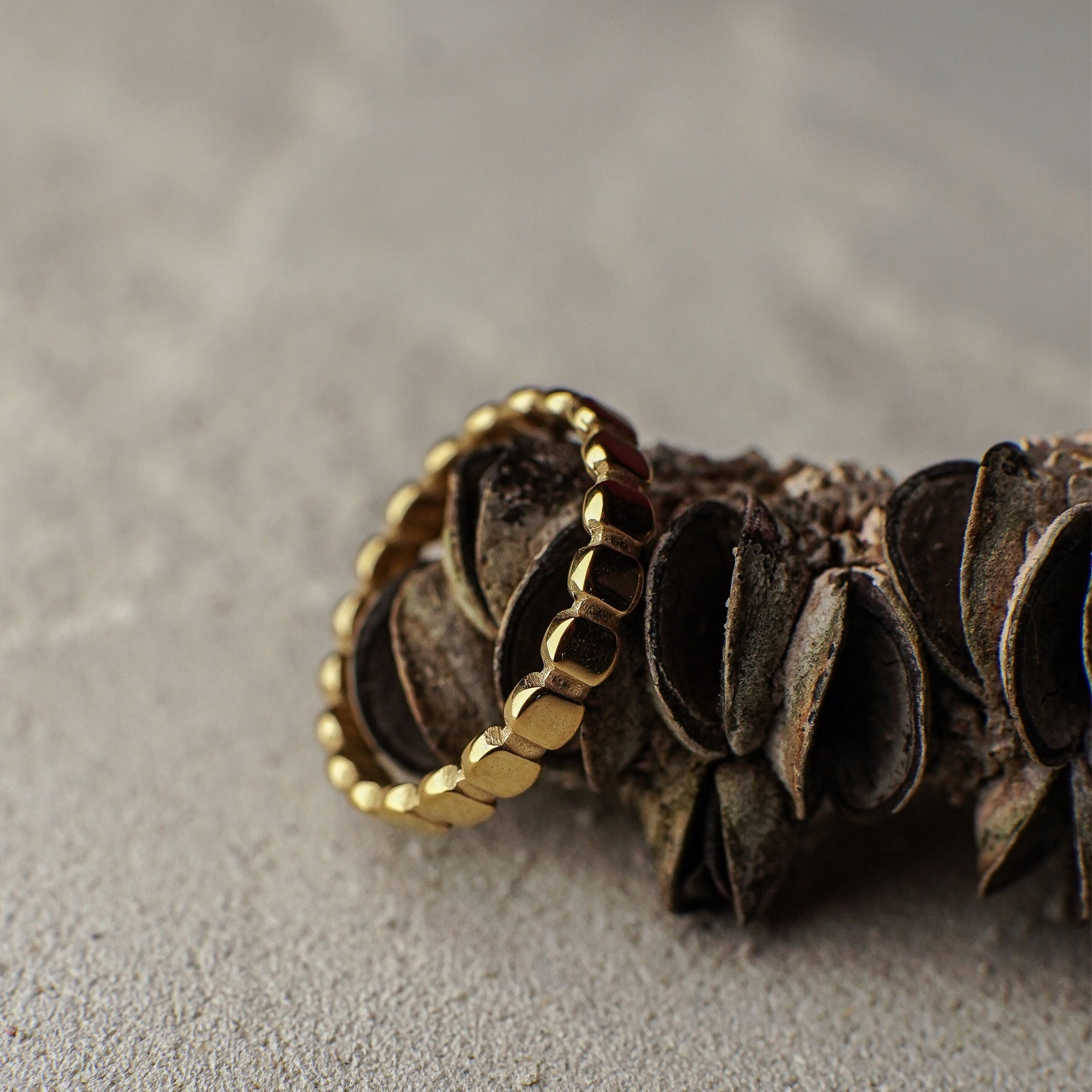 Gold hoop earrings on a textured surface