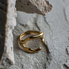 Gold ring on a textured stone surface