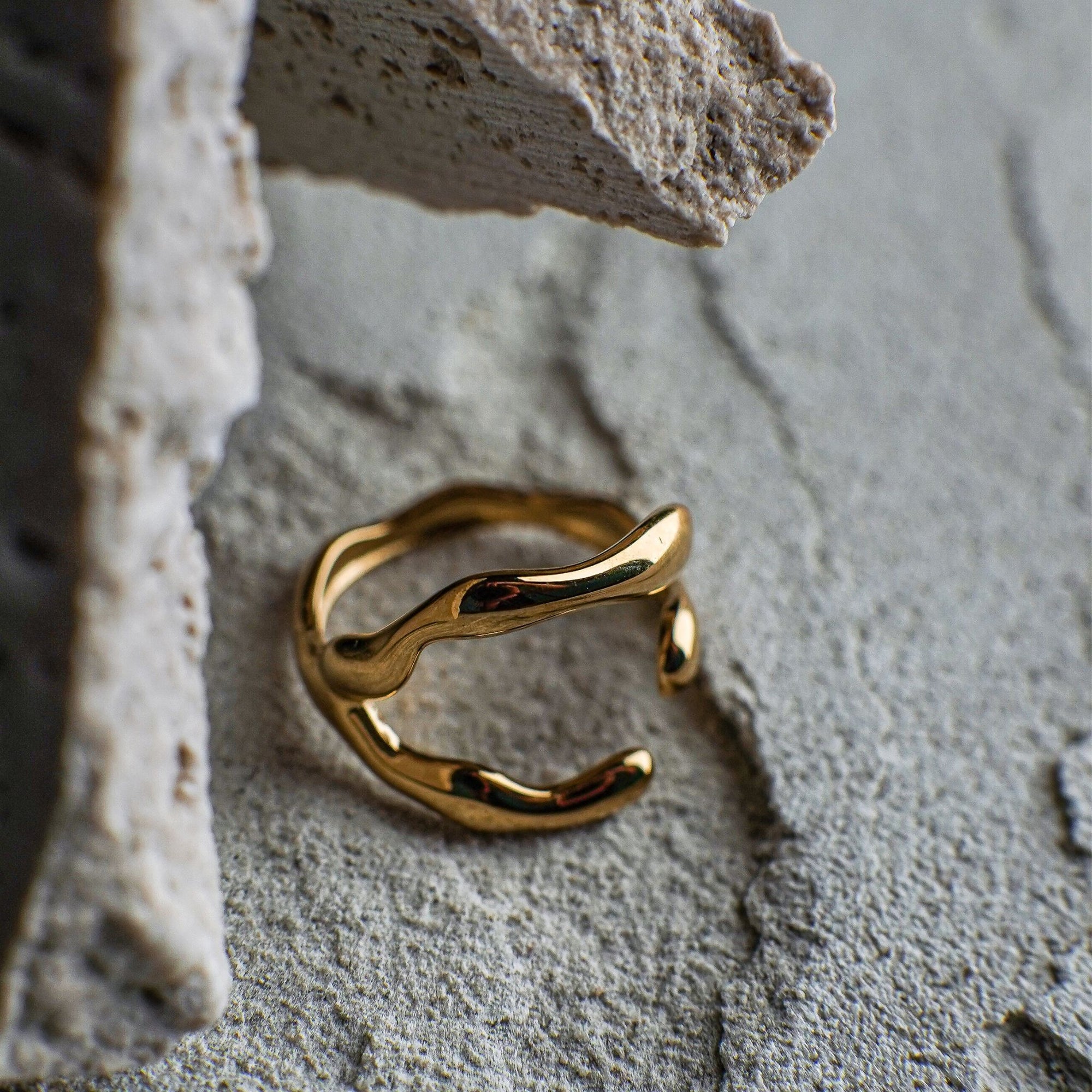 Gold ring on a textured stone surface