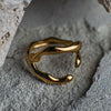 Gold ring on a textured stone surface
