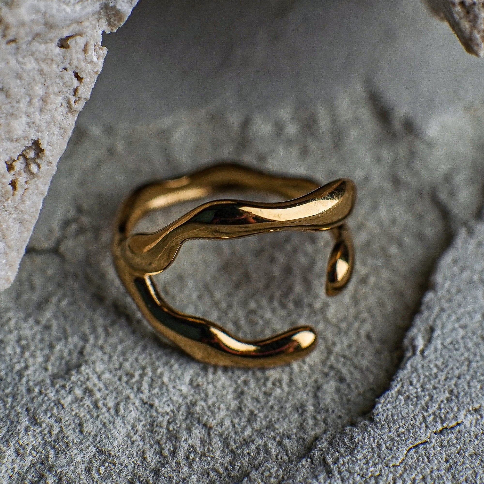 Gold ring on a textured stone surface