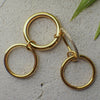 Gold hoop earrings with a textured surface background