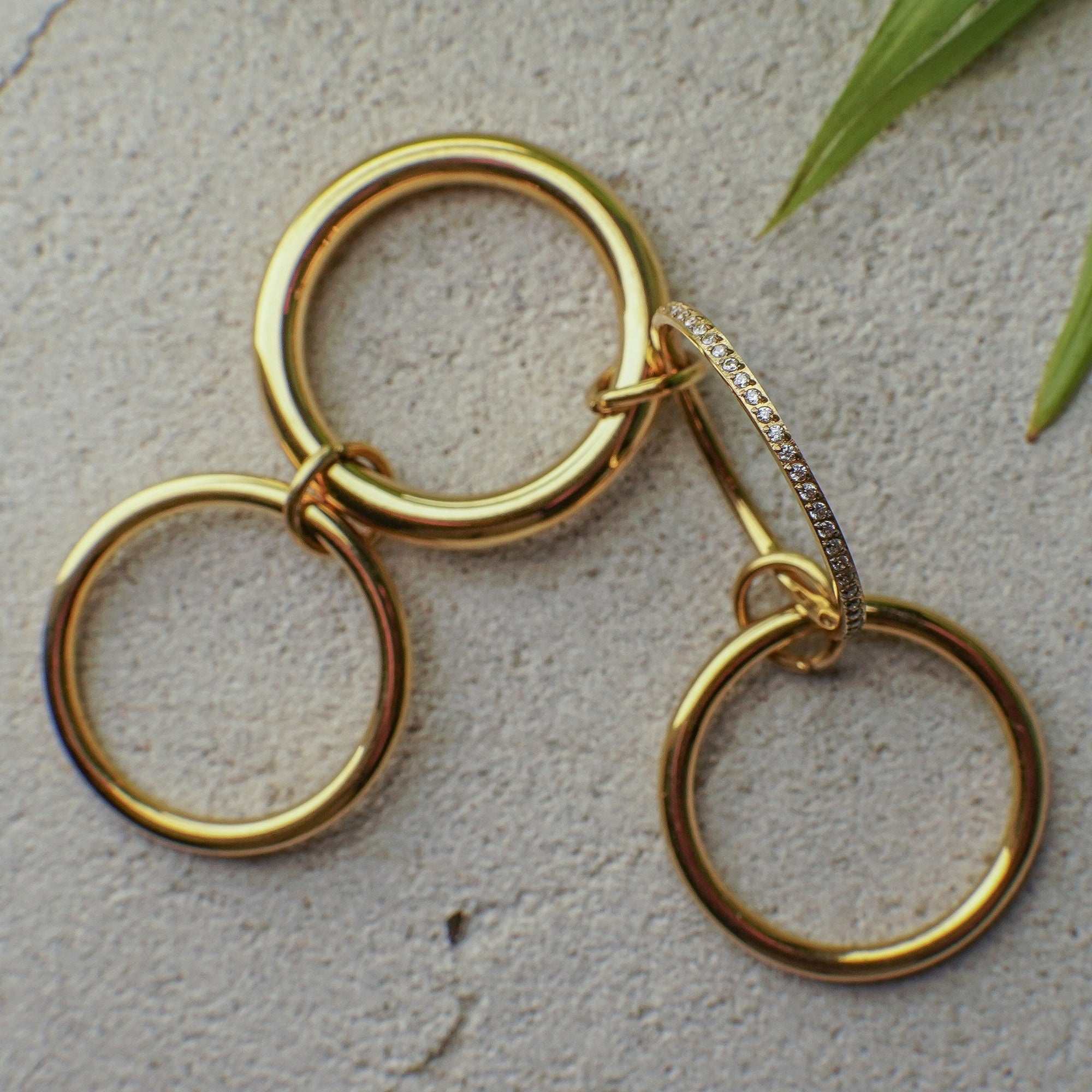 Gold hoop earrings with a textured surface background