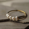 Pearl bracelet with gold accents on a textured surface