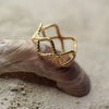 Gold ring with a textured design on a shell