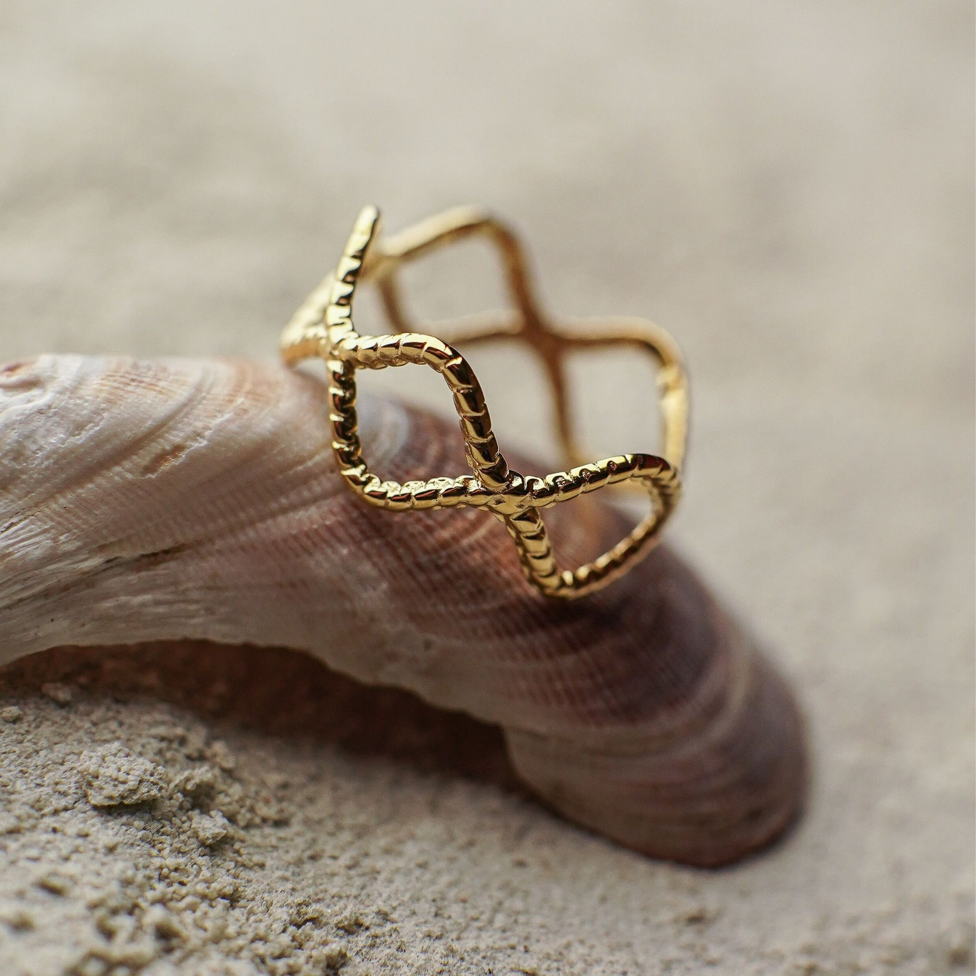 Gold ring with a textured design on a shell