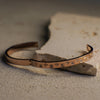 Decorative leather belt with engraved patterns on a textured surface