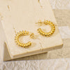 Gold twisted hoop earrings with a playful, twirly design.