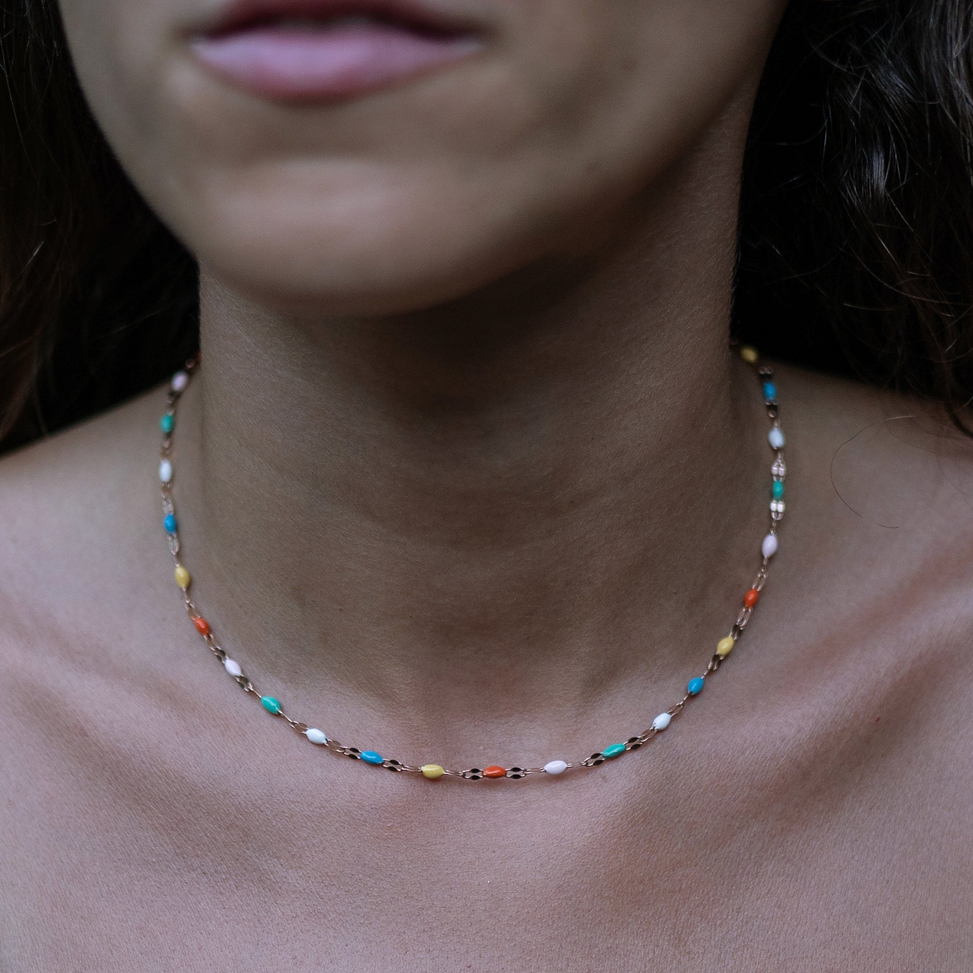 A model wearing a colorful beaded necklace