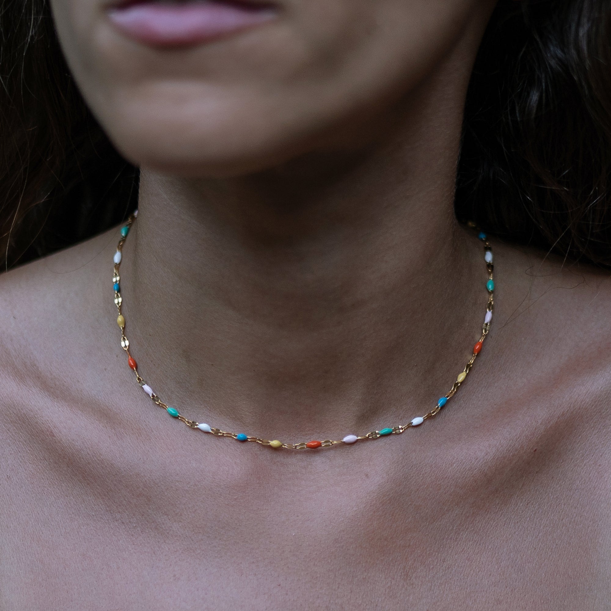 A model wearing a colorful beaded necklace