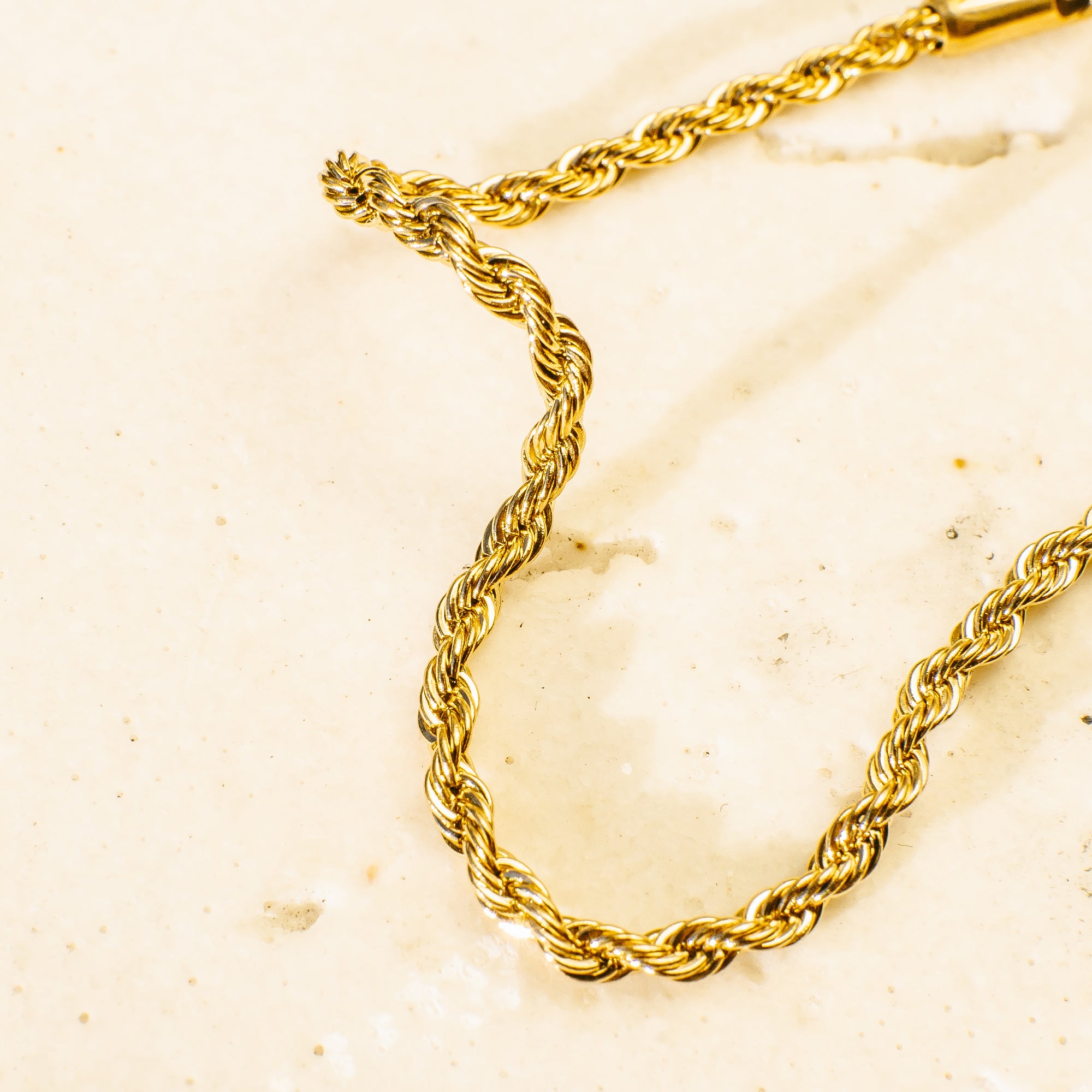 Gold bracelet with an intricate braided design.