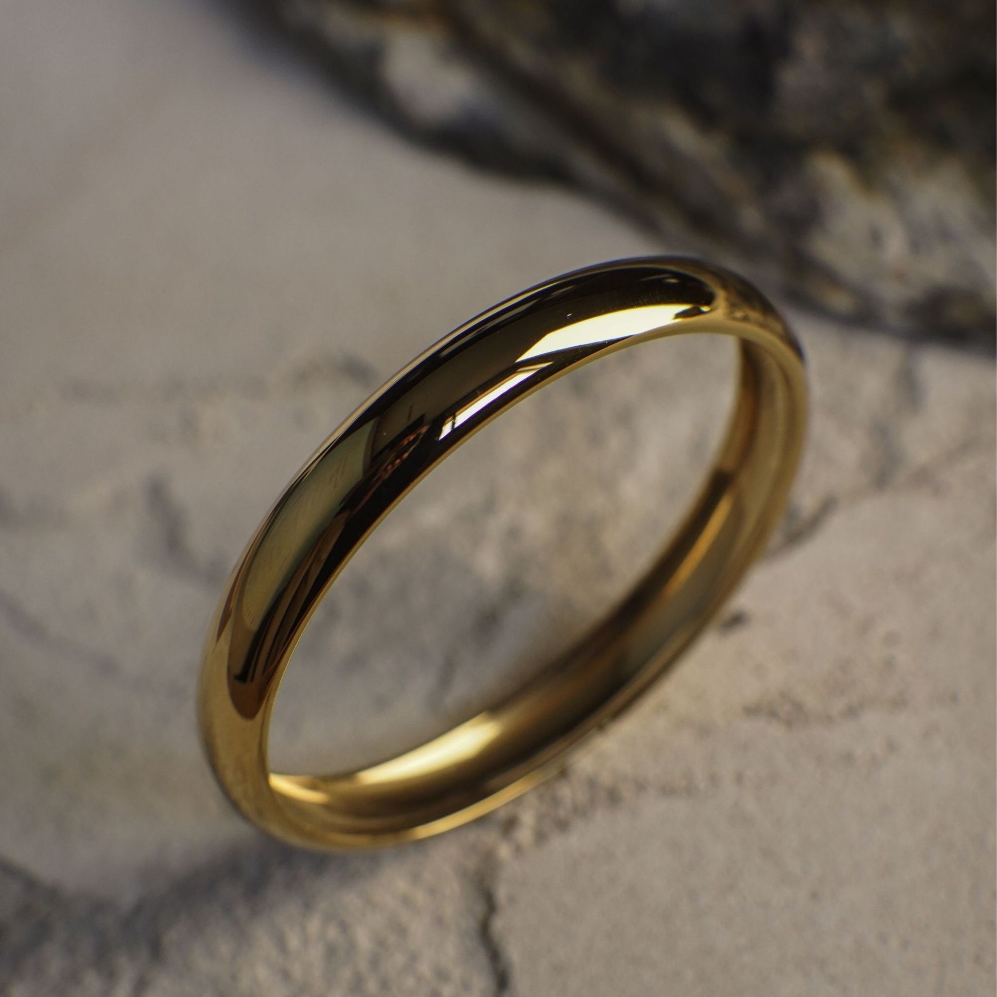 Gold ring on a textured stone surface
