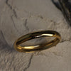 Gold ring on a textured stone surface