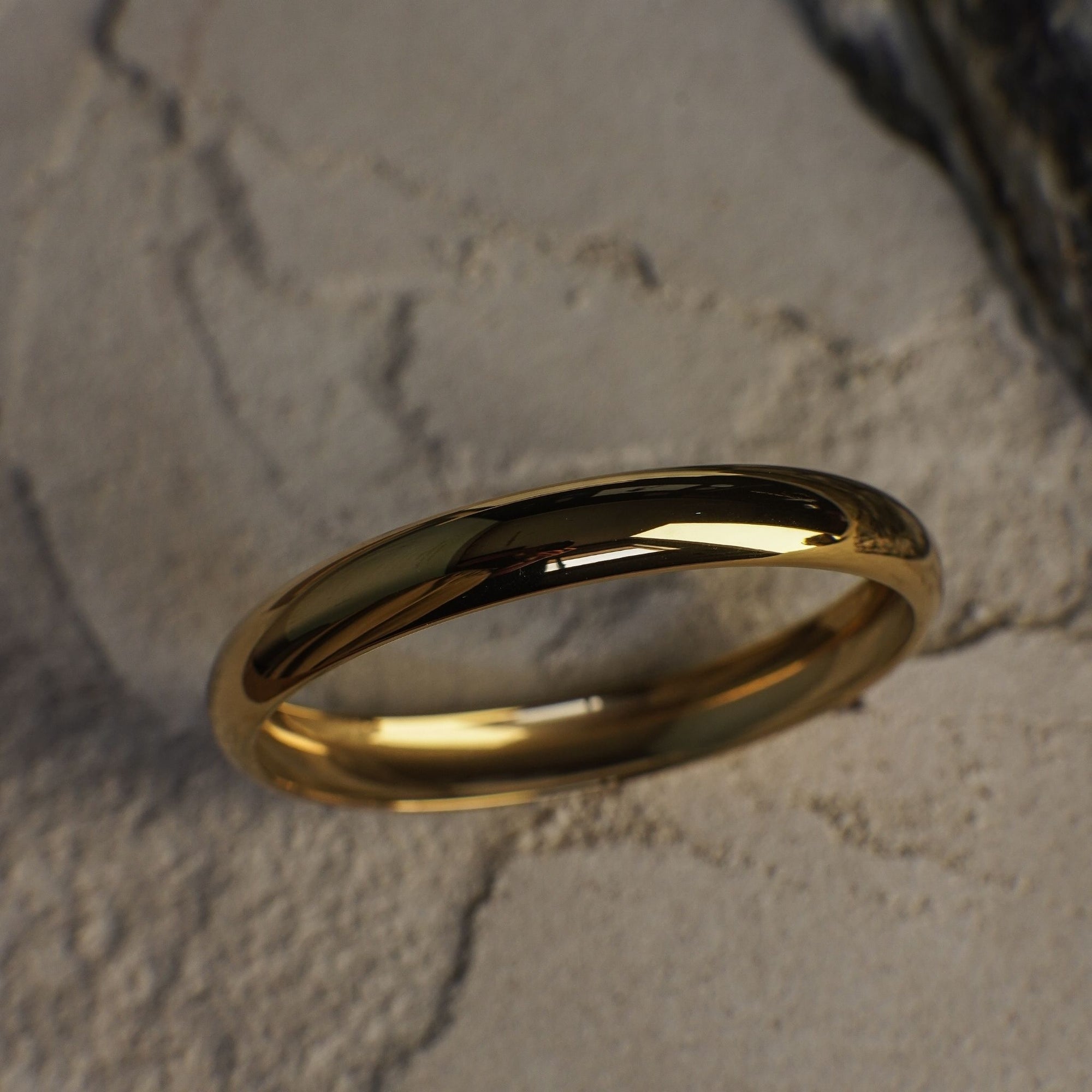 Gold ring on a textured stone surface