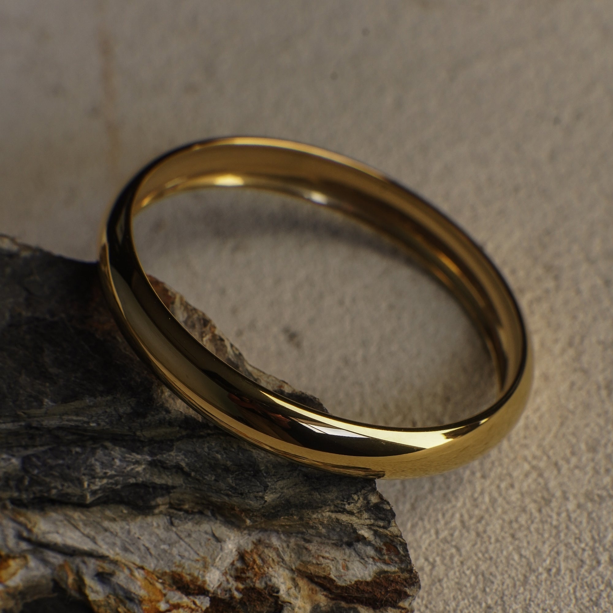 Gold ring on a textured stone surface
