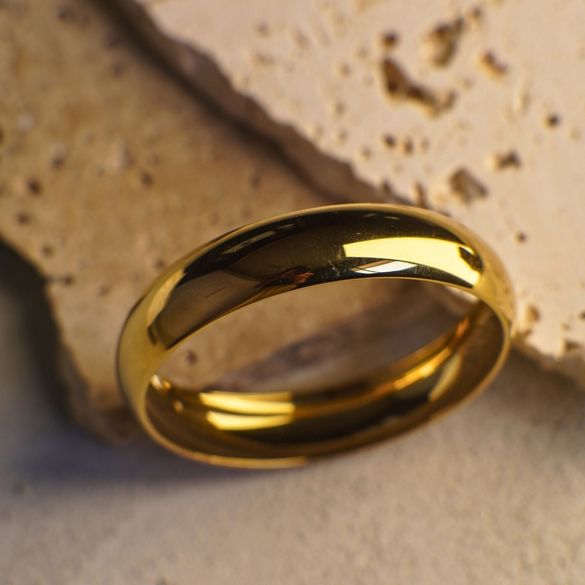 Gold ring on a textured stone surface
