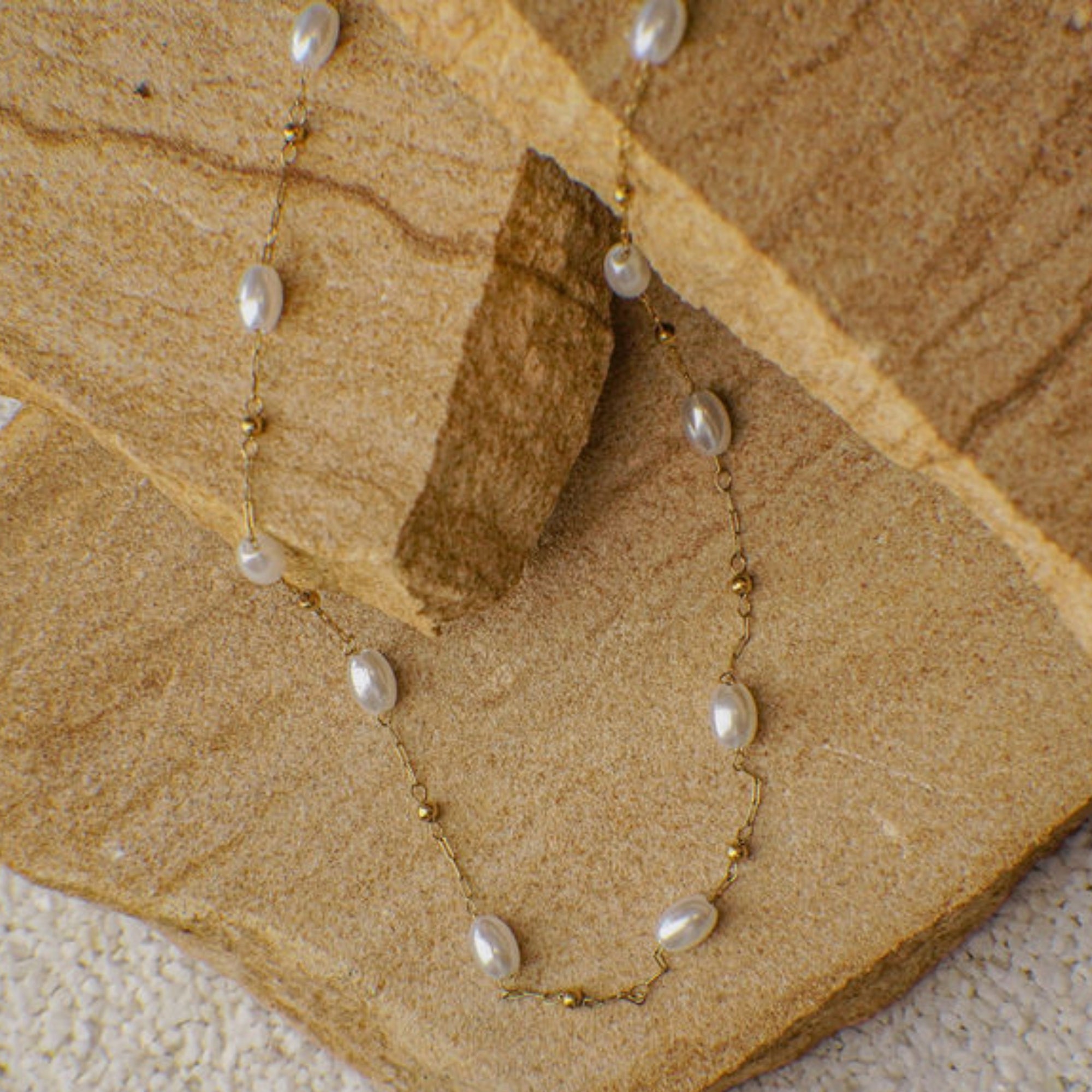 Pearl necklace on a stone surface