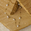 Pearl necklace on a textured beige surface