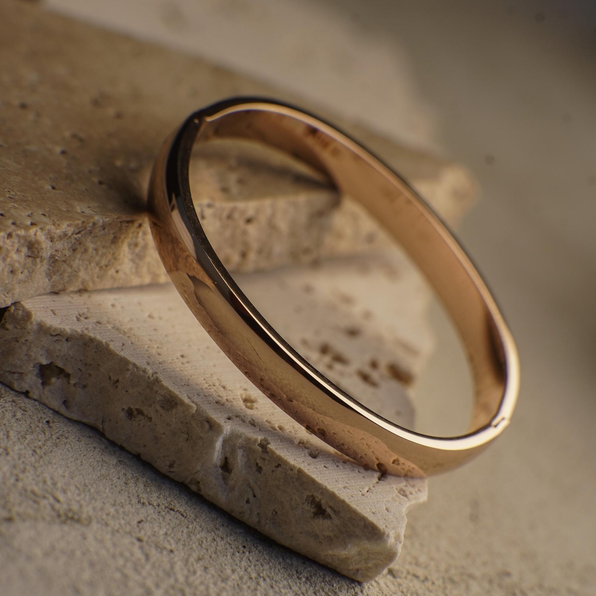 Gold ring on a textured stone surface