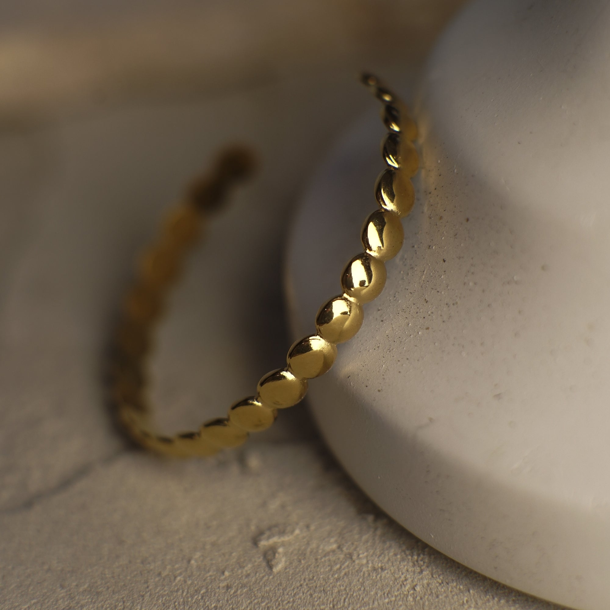 Gold bracelet on a textured surface