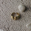 Gold ring on a textured stone surface