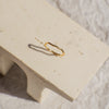 Gold ring on a beige stone surface