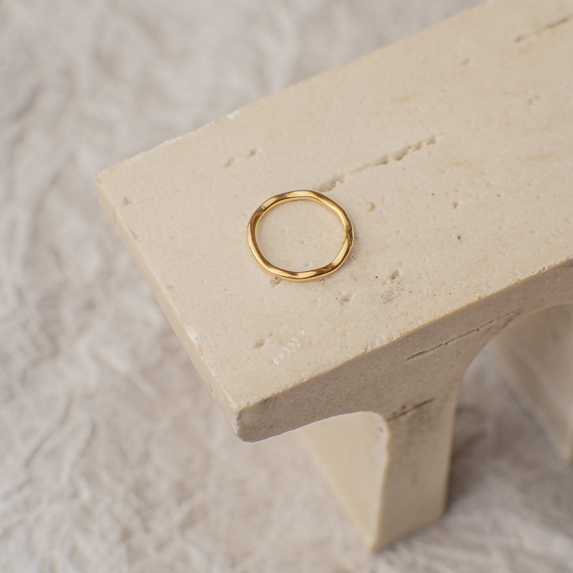 Gold ring on a textured stone surface