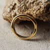 Gold ring on a textured stone surface