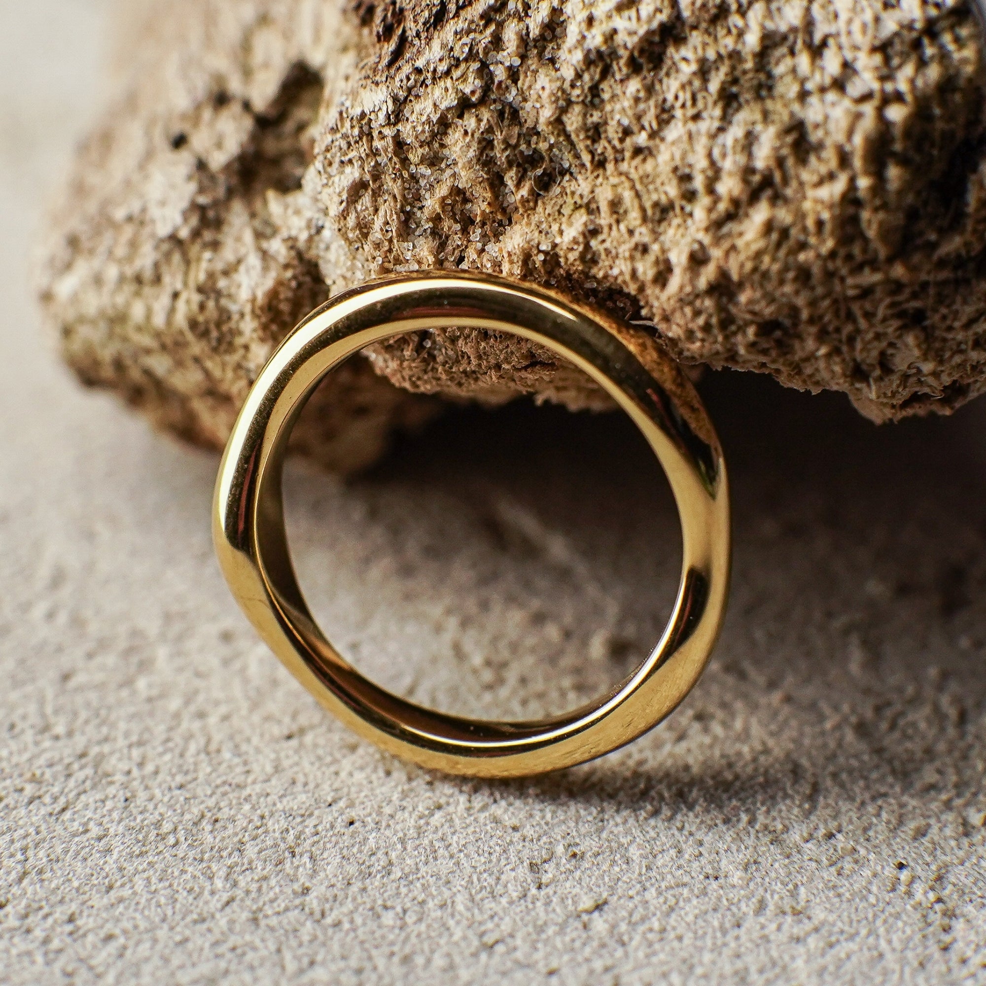 Gold ring on a textured stone surface