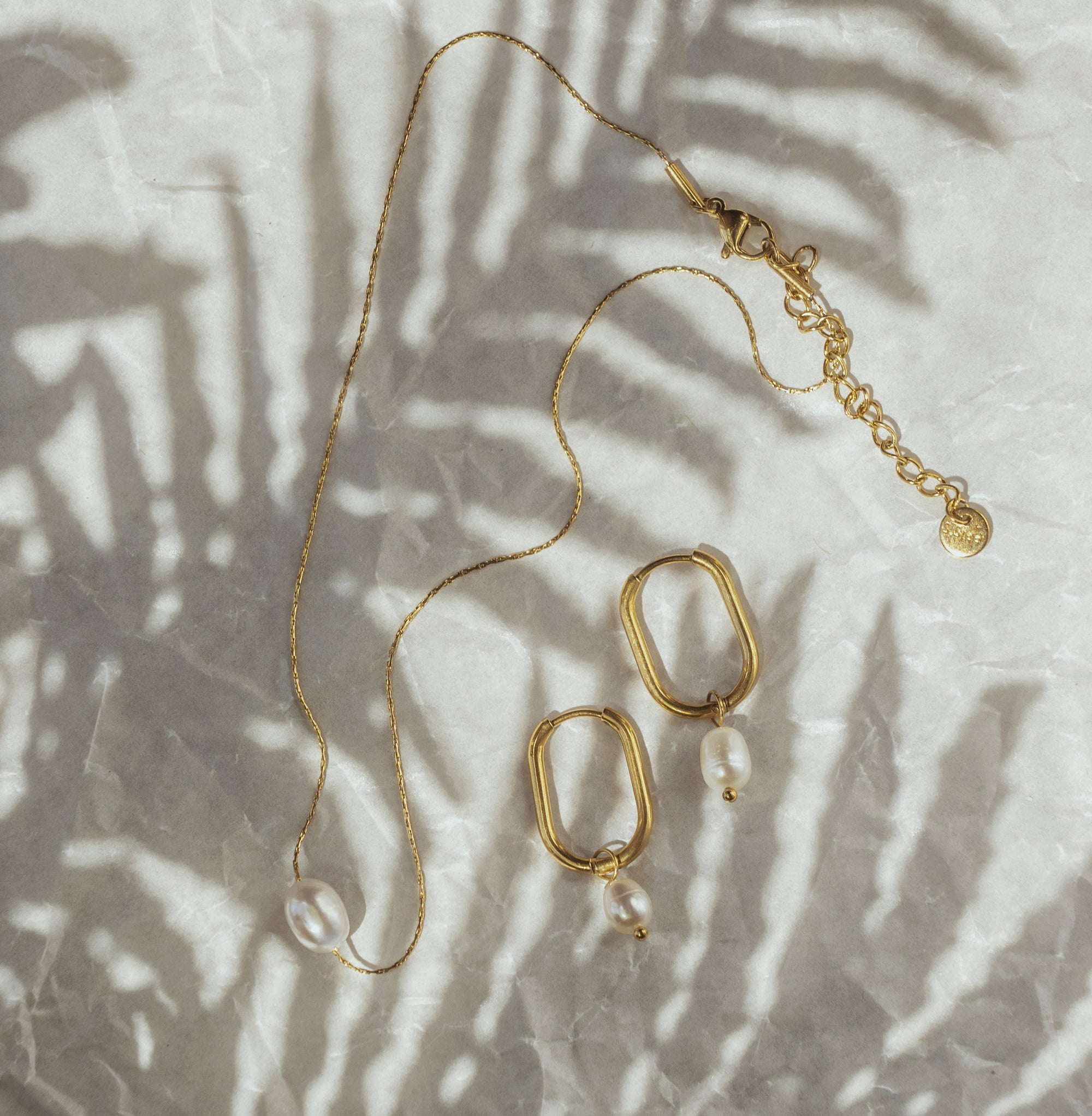 Mara Gold Pearl Earrings when paired with a necklace with the same design