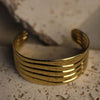 Gold bracelet on a textured surface