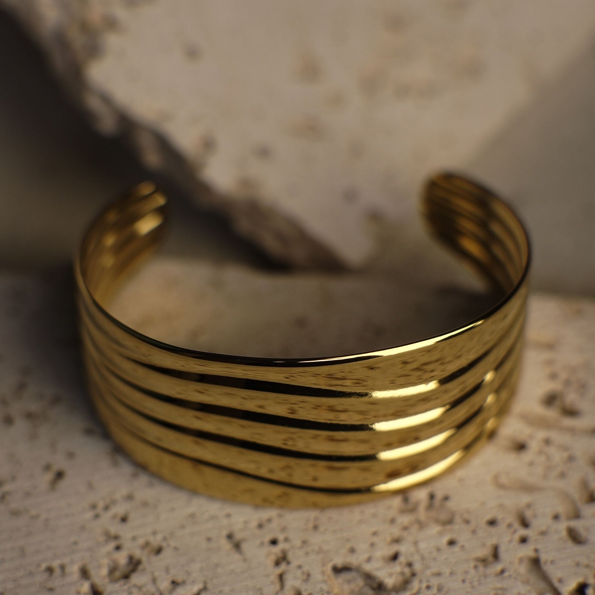 Gold bracelet on a textured surface