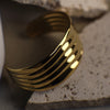 Gold bracelet on a textured surface