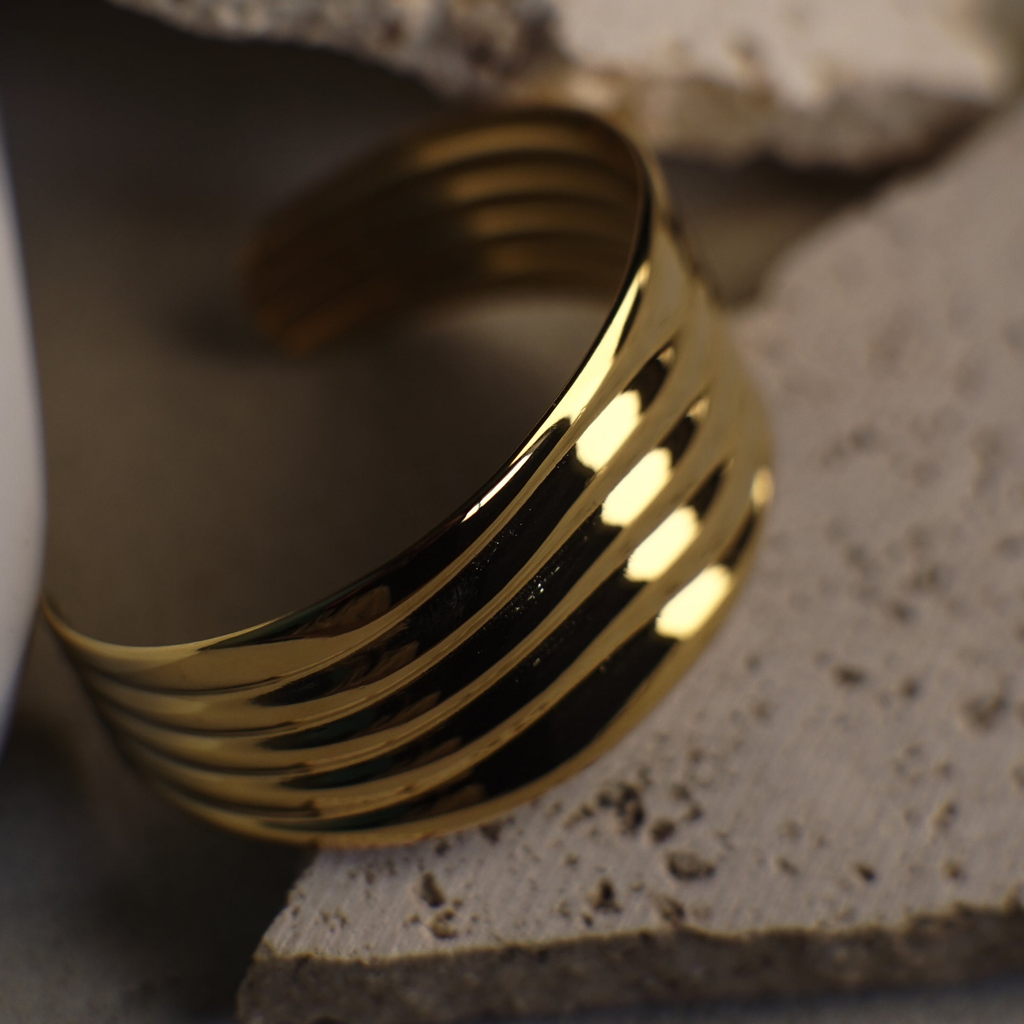 Gold bracelet on a textured surface