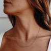 A model wearing a gold chain necklace