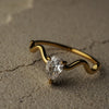 Gold bracelet with a diamond on a textured surface