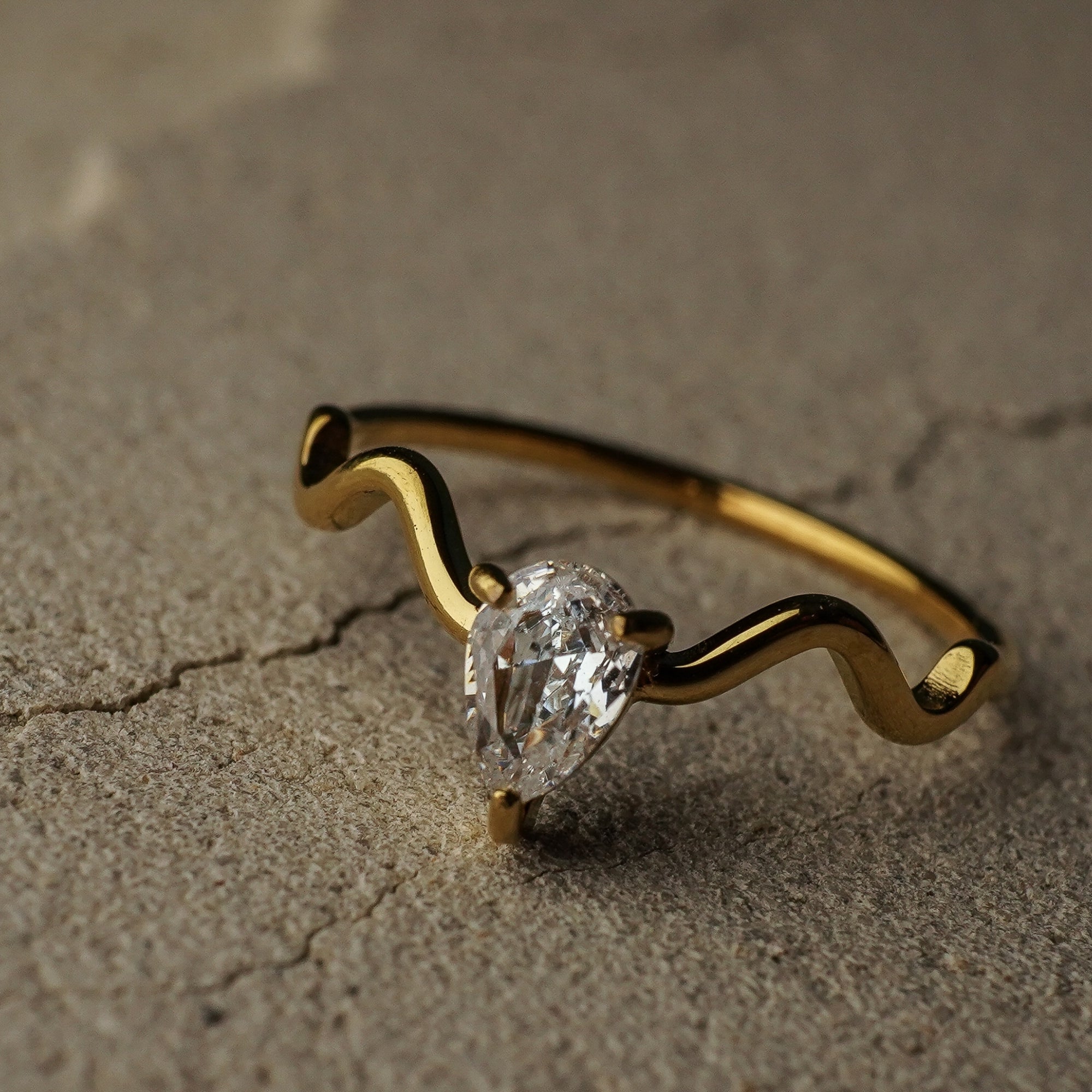 Gold bracelet with a diamond on a textured surface