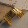 Gold bracelet on a textured stone surface