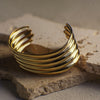 Gold bracelet on a textured stone surface