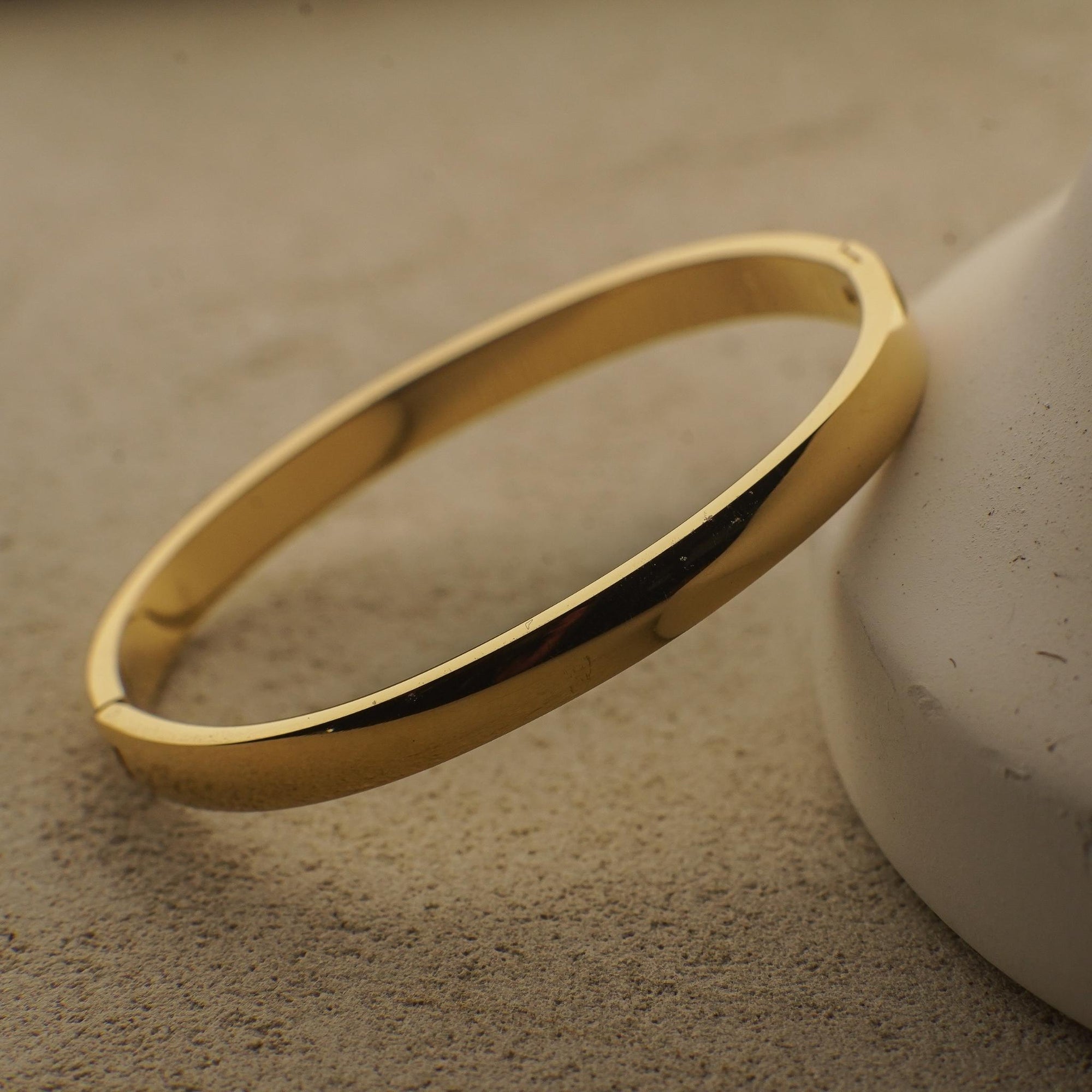 Gold bracelet on a textured surface