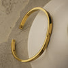 Gold bracelet on a textured surface