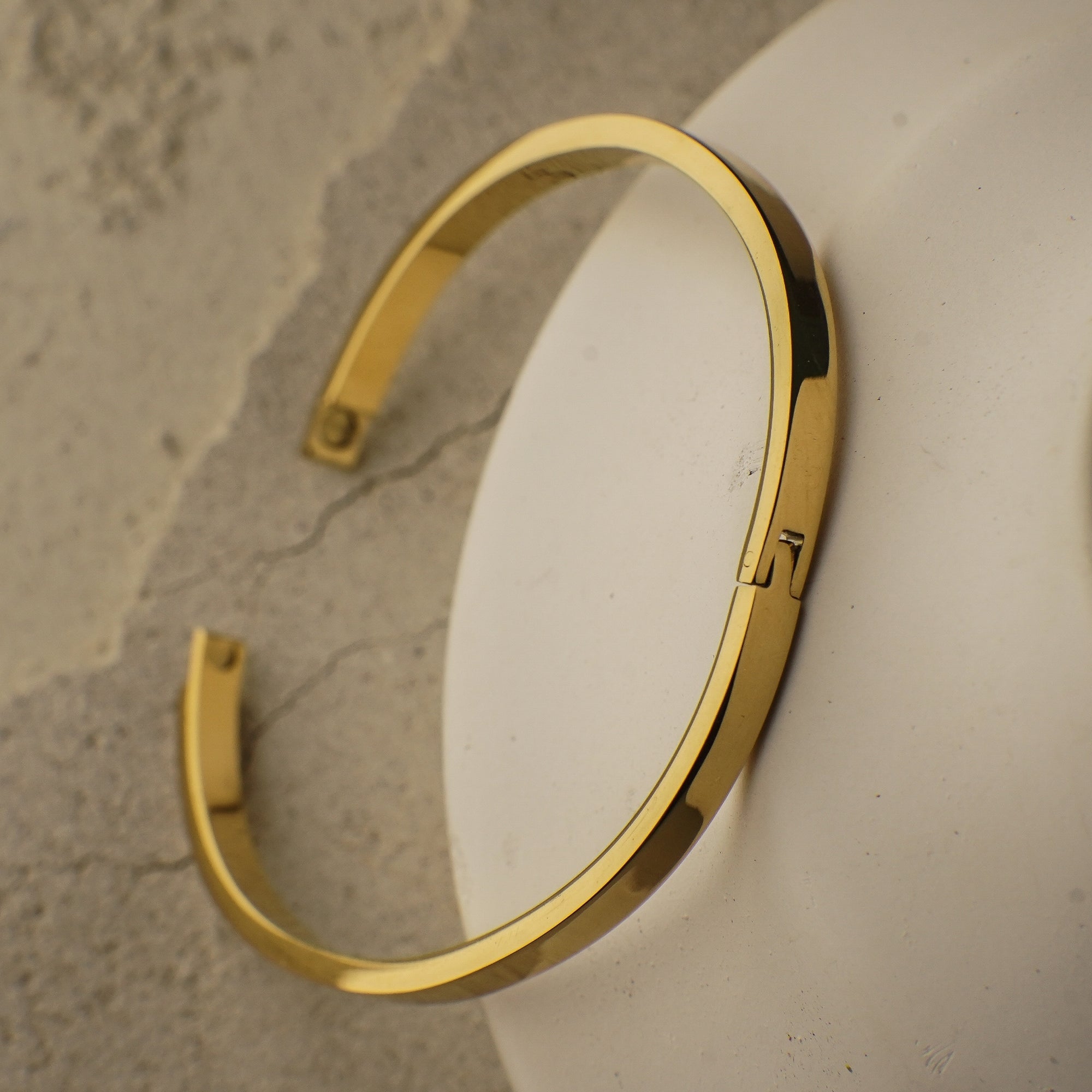Gold bracelet on a textured surface