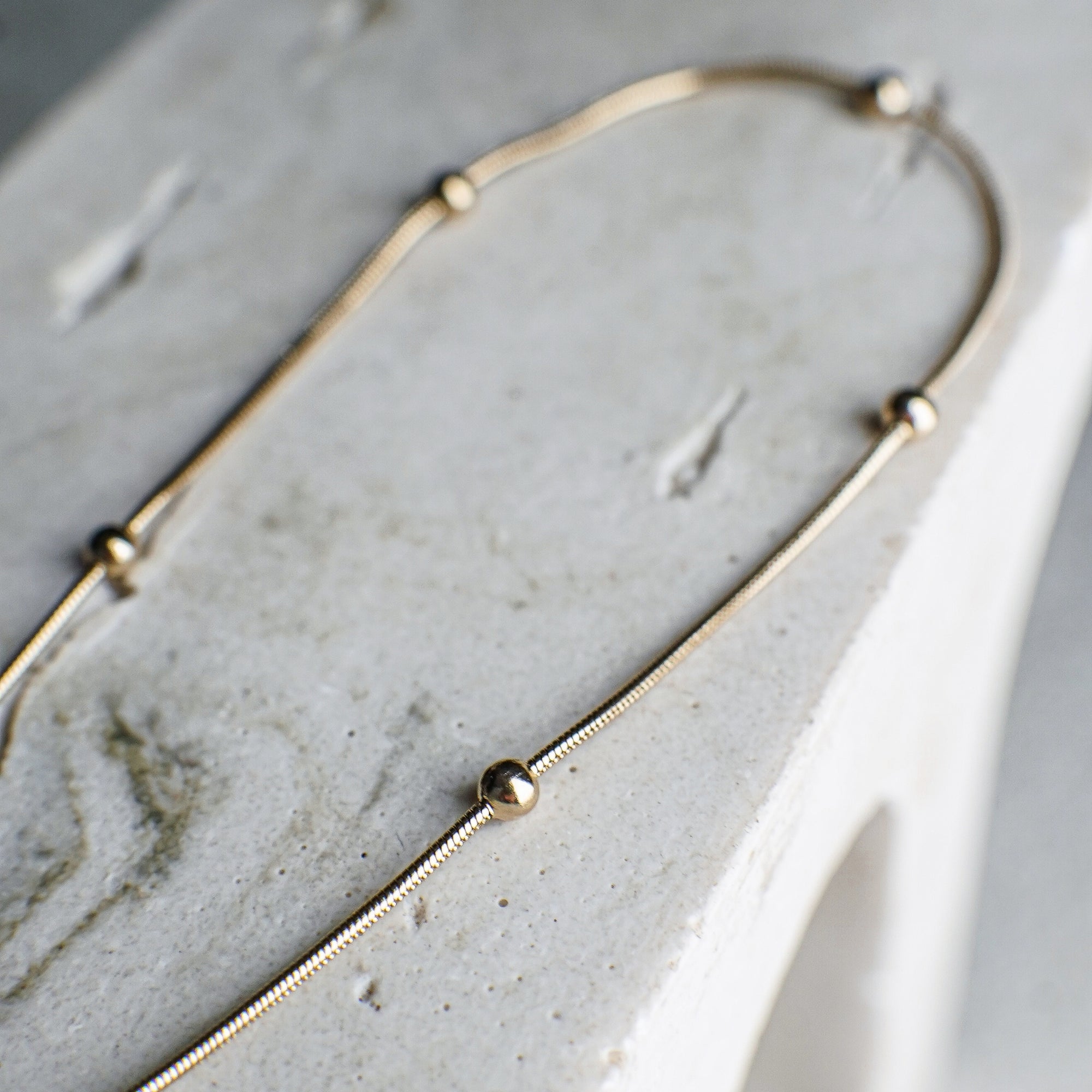 Gold necklace on a marble surface